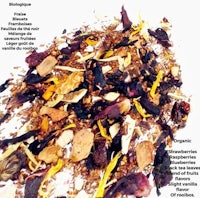 a pile of dried fruit and herbs on a white background