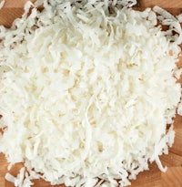 shredded coconut on a wooden cutting board