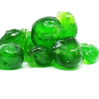 a pile of green gummy candy on a white background