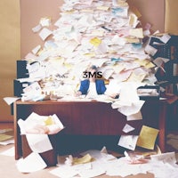 a person sitting at a desk with a pile of papers