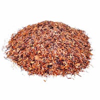 a pile of red rooibos tea on a white background