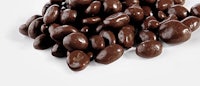 a pile of chocolate covered nuts on a white background