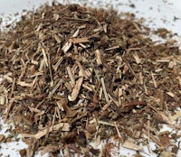 a pile of dried herbs on a white plate