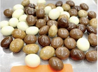 a pile of chocolate and white eggs on a table