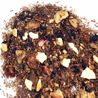 a pile of dried fruit and nuts on a white surface