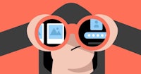 a person in a hoodie looking through binoculars
