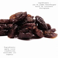 a pile of dried raisins on a white background