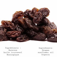 a pile of raisins on a white background
