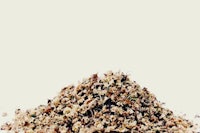 a pile of dried herbs on a white background