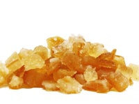 a pile of orange crystals on a white background