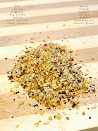 a pile of spices on a wooden cutting board