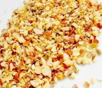 a pile of nuts and seeds on a white surface