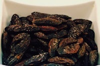 dried figs in a white bowl on a table