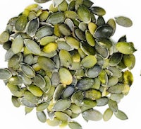 a pile of pumpkin seeds on a white background
