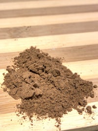 cocoa powder on top of a wooden cutting board