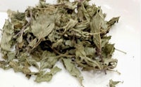 a pile of dried leaves on a white plate