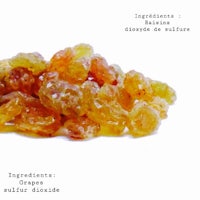 a pile of dried grapes on a white background
