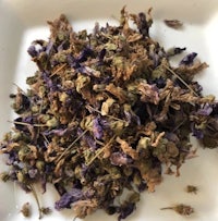 a pile of dried flowers on a white plate
