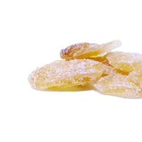 a pile of sugared ginger pieces on a white background