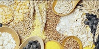 a variety of grains and seeds are arranged in a wooden bowl
