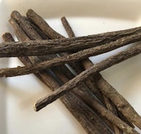a white plate with a bunch of licorice sticks on it