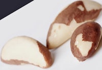a white plate with three pieces of nuts on it