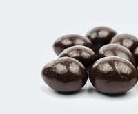a pile of chocolate balls on a white background