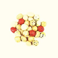 a pile of different colored nuts on a white background