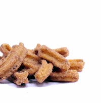 a pile of fried churros on a white background
