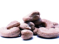 a pile of cashew nuts on a white background