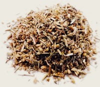 a pile of dried herbs on a white surface