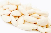a pile of white almonds on a white background
