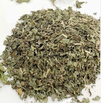 a pile of dried herbs on a white surface