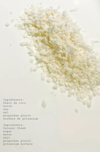 a pile of white shredded coconut on a white surface