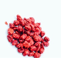 a pile of red berries on a white background