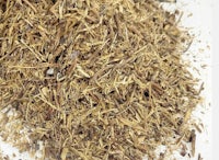 a pile of dried leaves on a white surface