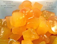 a white bowl with different kinds of oranges in it
